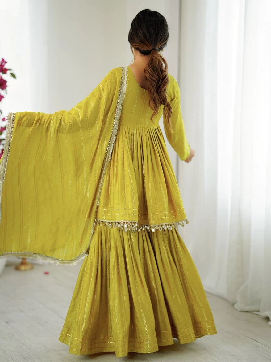 Woman wearing a yellow traditional outfit with a white background