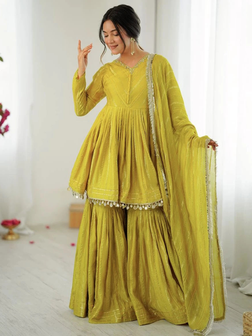 Woman wearing a yellow traditional outfit with a white background