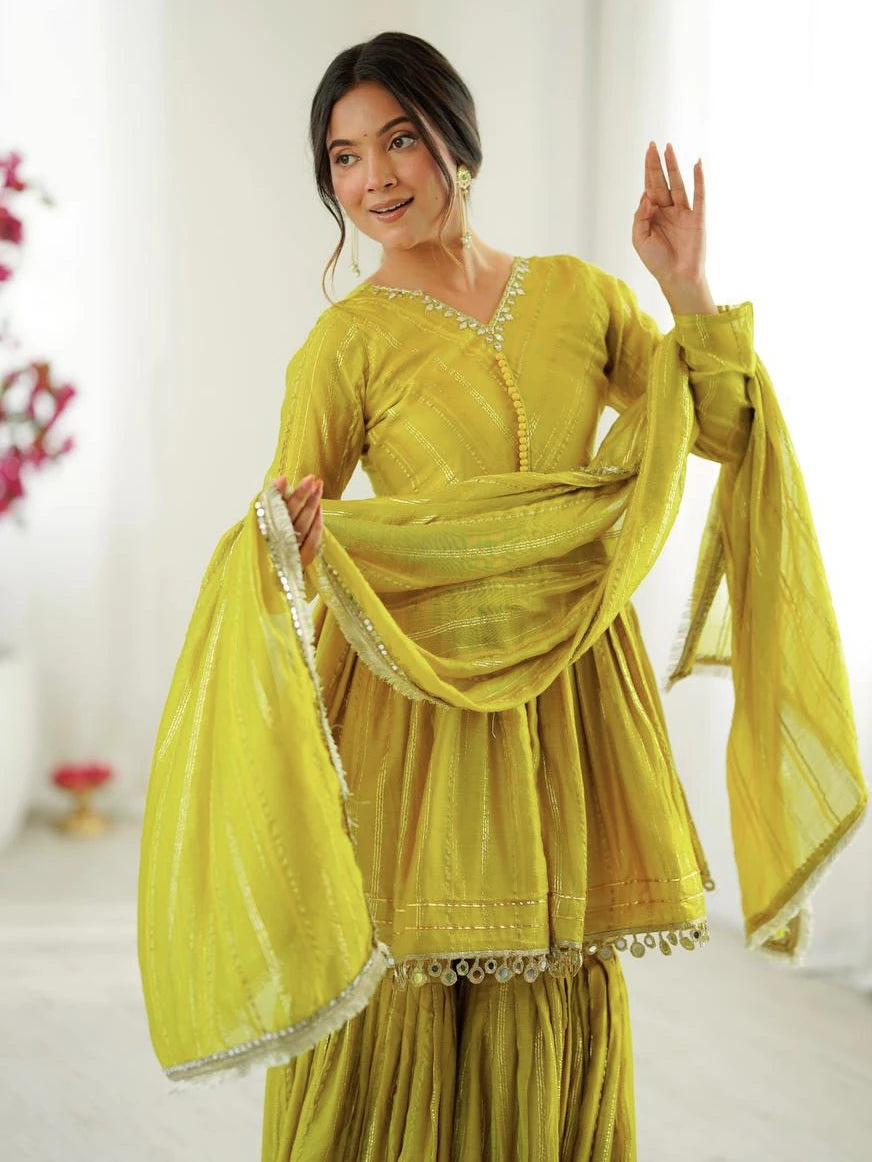 Woman wearing a yellow traditional outfit with a matching dupatta in a bright setting