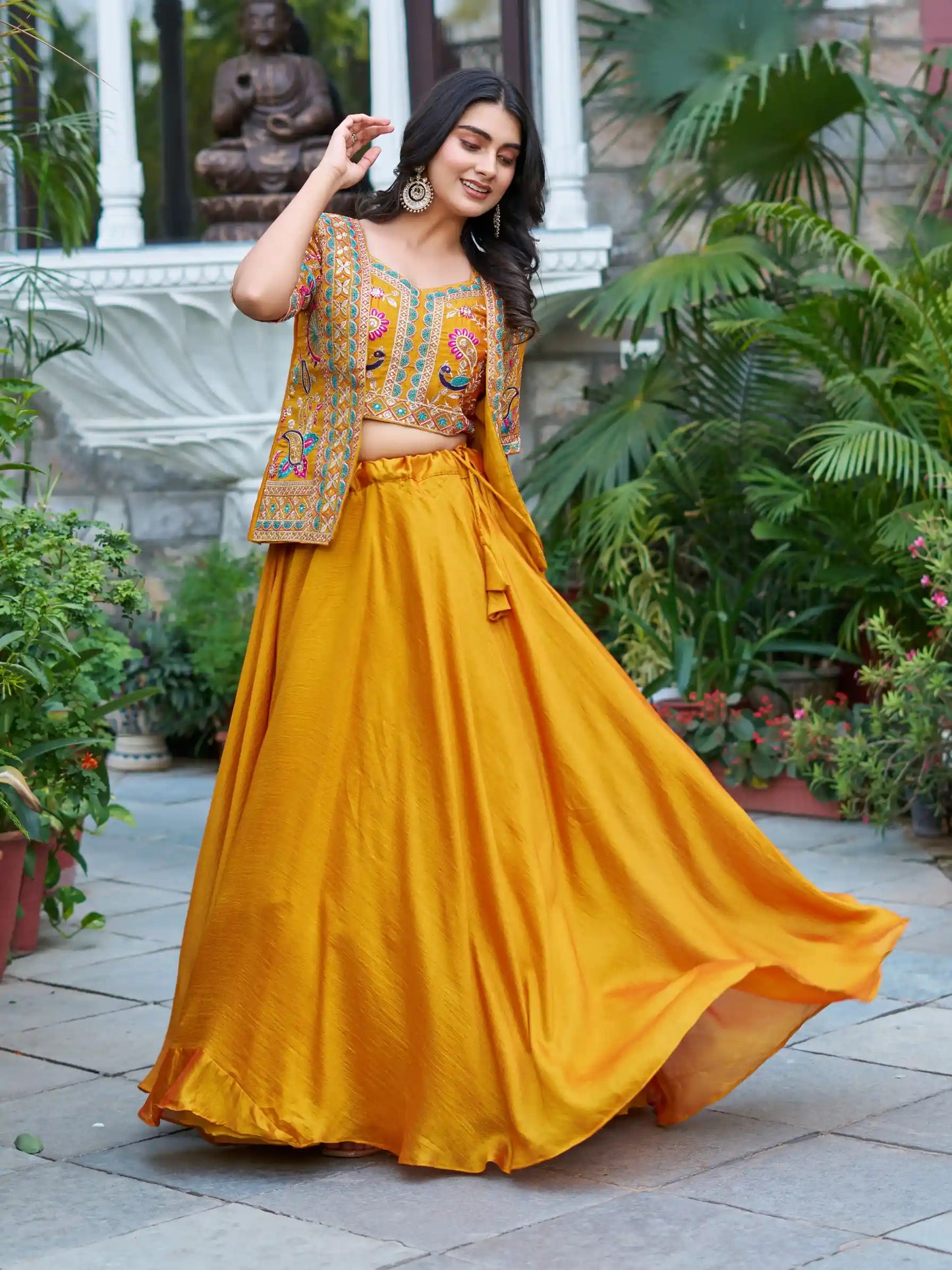 Woman in a yellow traditional outfit with a colorful blouse in an outdoor setting.